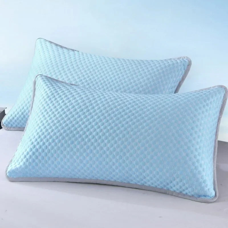 A hand pressing down on the pillow's surface to show the fabric's softness.