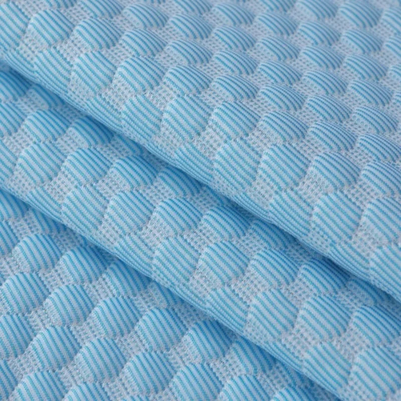 Close-up of the quilted fabric weave from another angle, showing the diamond pattern.