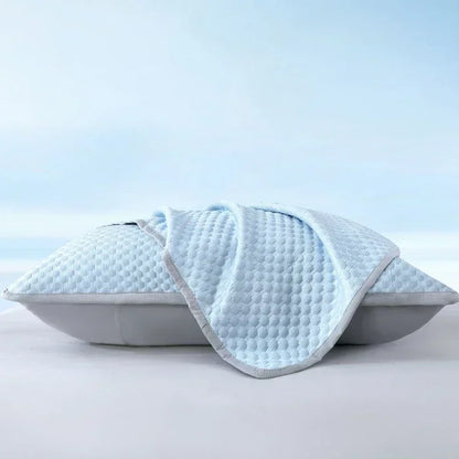 Blue pillow cover on a pillow, shown at an angle on a plain background.