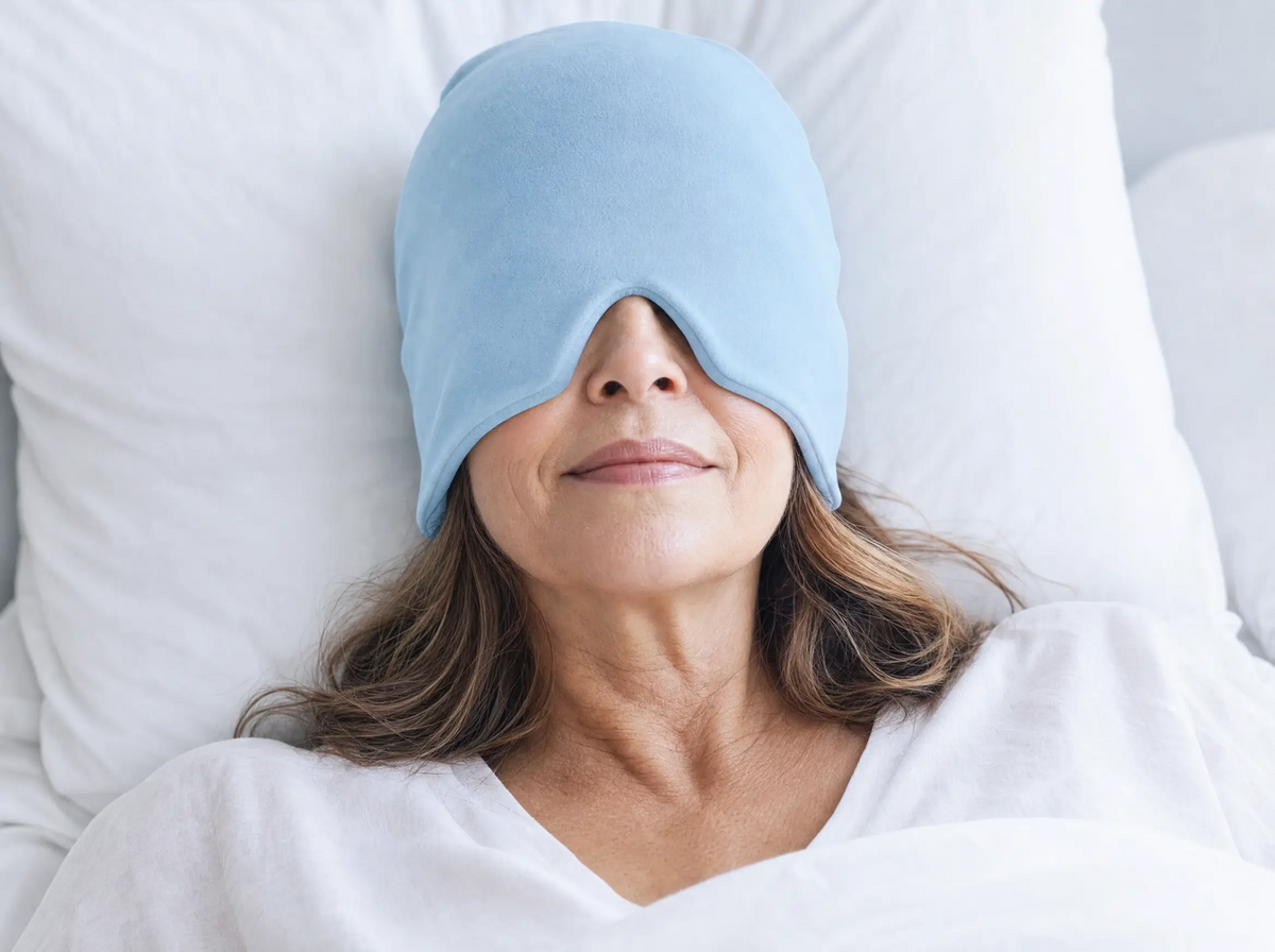 Woman resting in bed wearing the blue cooling gel head wrap