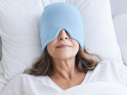 Woman resting in bed wearing the blue cooling gel head wrap